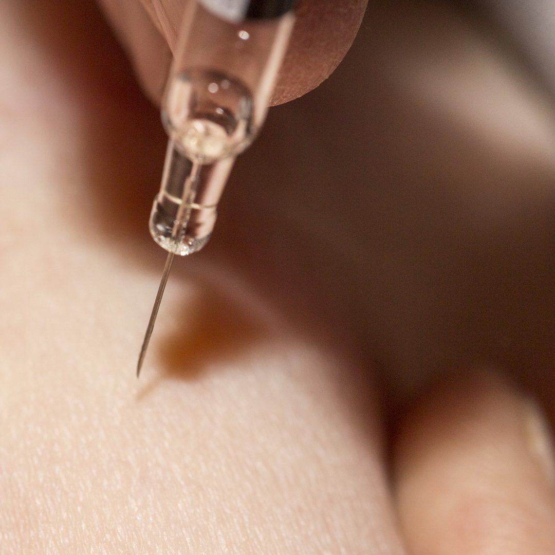 Medical diabetes insulin syringe injection shot into abdomen